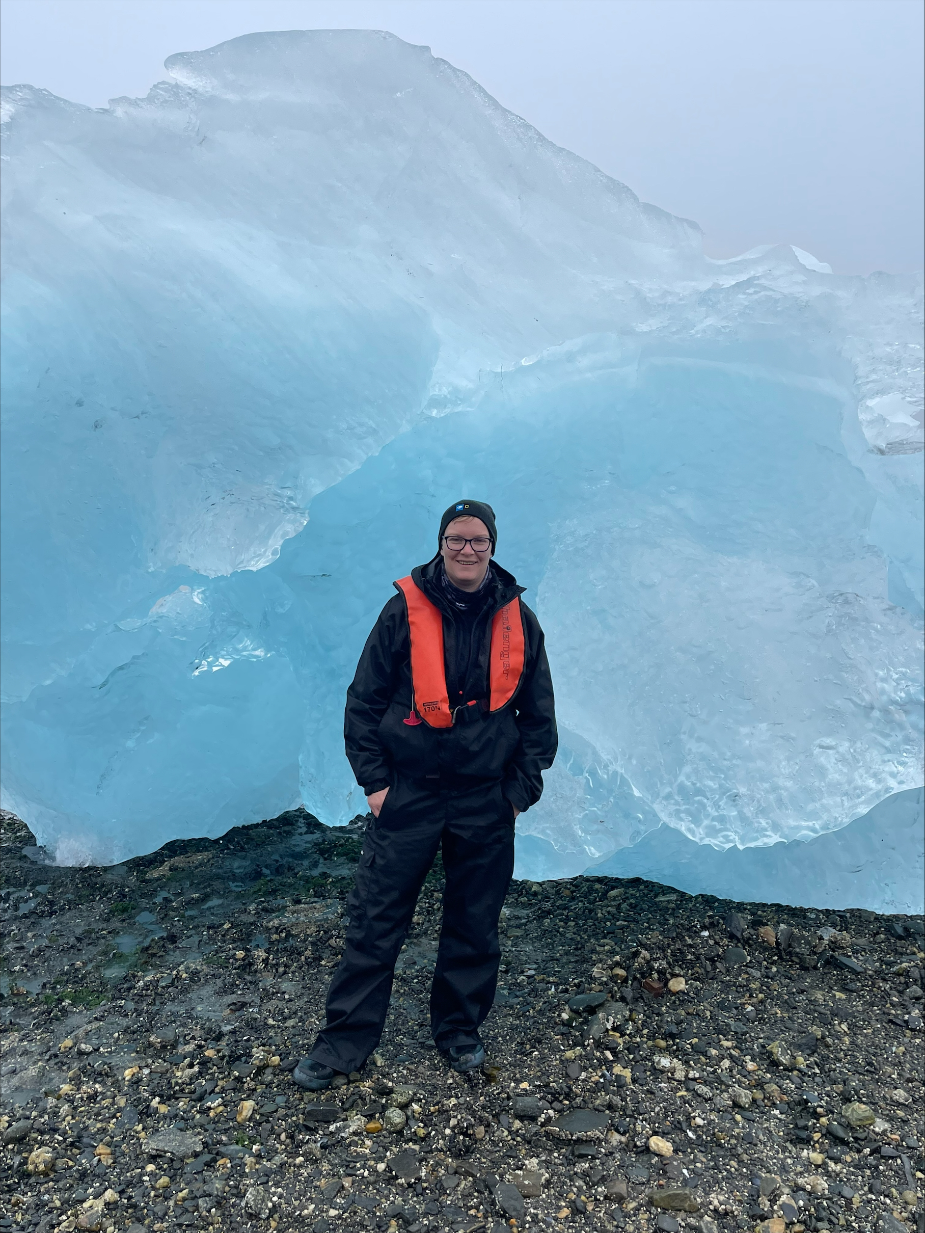 a man standing on top of a snow covered mountain