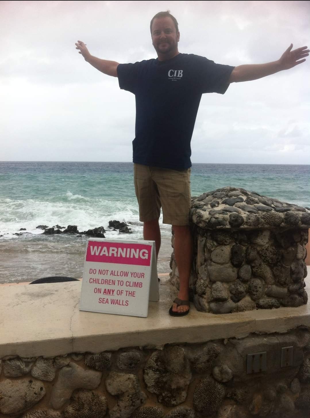 a man standing on a rocky beach